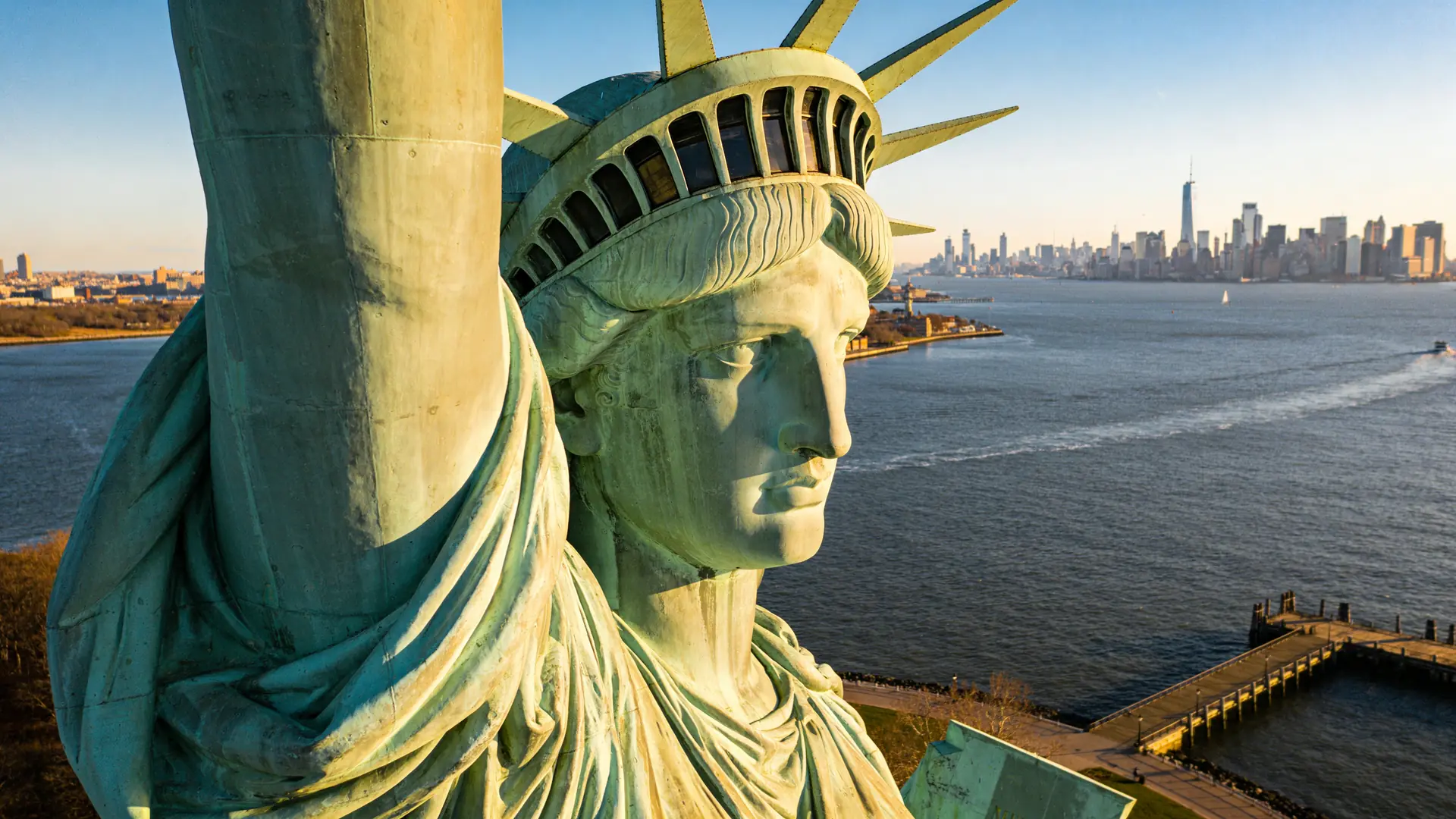 Statue of Liberty at golden hour from the harbor — how to visit Statue of Liberty trip planning context