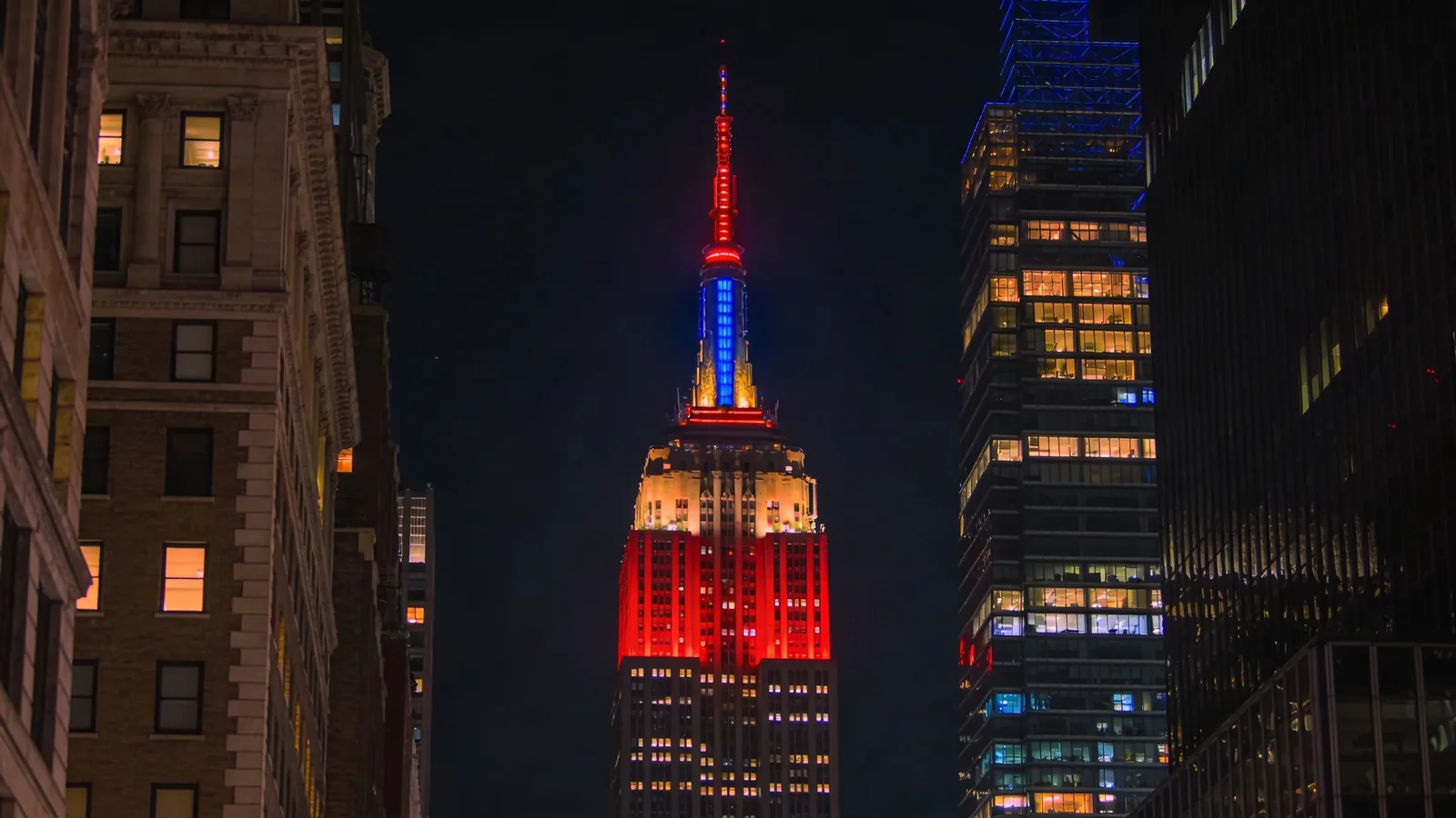 Empire State Building tower at night with colorful crown lighting — Empire State Building visit tips evening visit