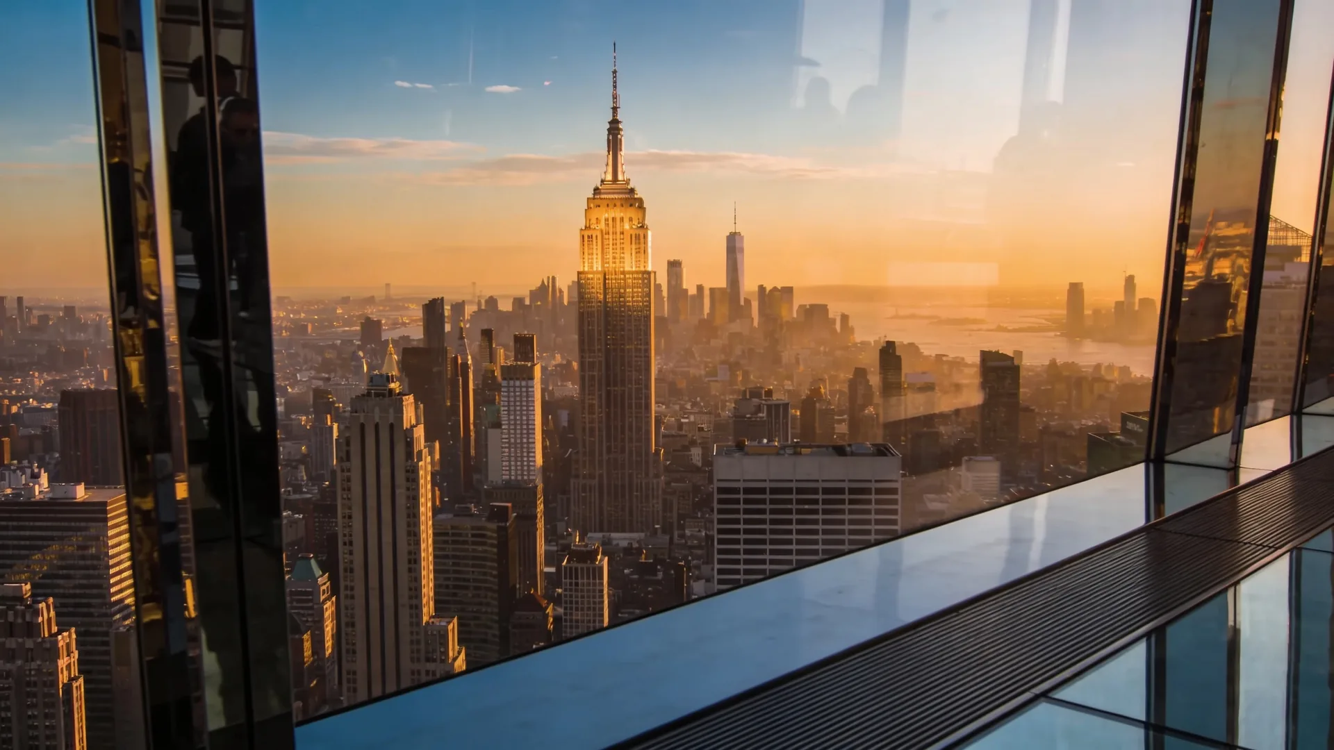Top of the Rock at golden hour with Empire State Building lit by sunset — best time to visit Top of the Rock cover