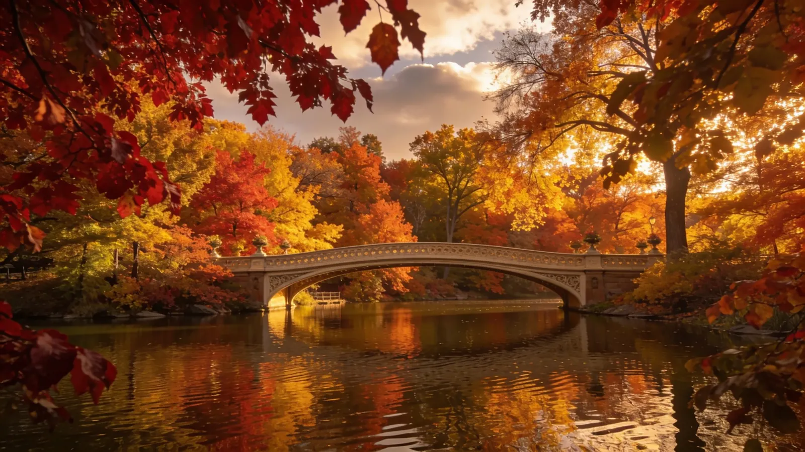 Bow Bridge in Central Park during peak fall with reflections in the Lake and colorful autumn trees — fall foliage in Central Park 2026 Peak 2