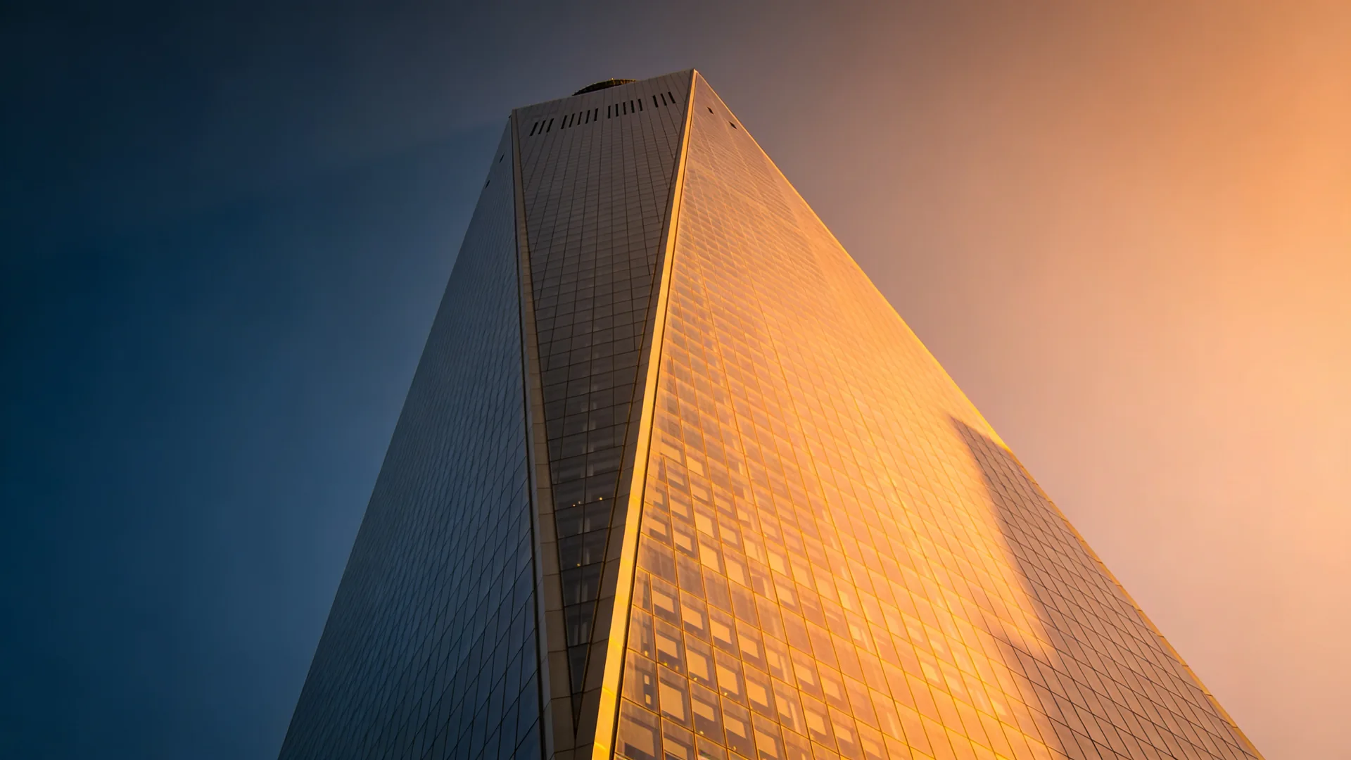 One World Trade Center tower at golden hour with sleek glass facade — Empire State vs One World Observatory cover
